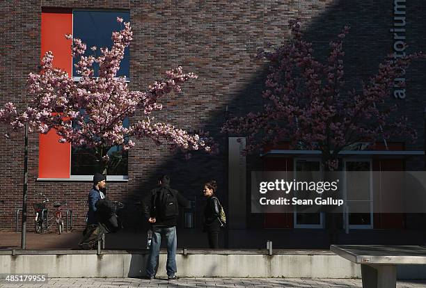 Students walk past buildings on the campus of the European University Viadrina on April 16, 2014 in Frankfurt an der Oder, Germany. The university is...