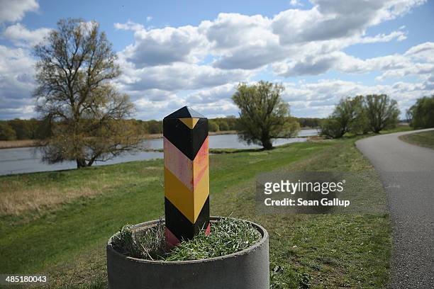 Marker indicates the official border line on the Germany side of the border with Poland as the Oder River and Poland are visible behind on April 16,...