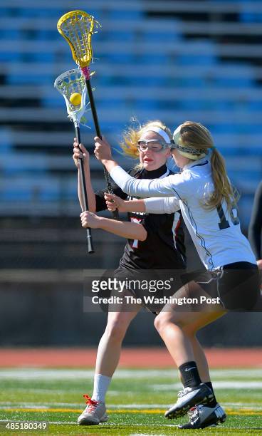 Madison's Katie Kerrigan, left, shoots a goal against the defense of Westfield's Maghan Heick, right, as Madison defeats Westfield in girls lacrosse...