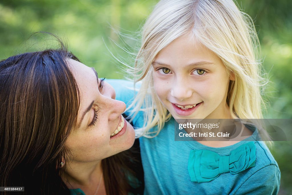 Portrait of mom looking at smiling daughter