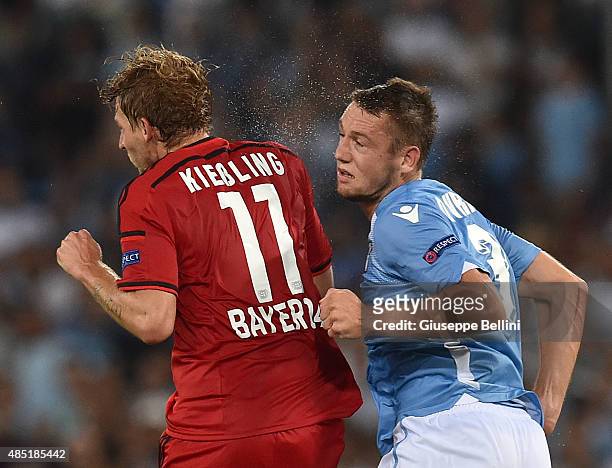 Stefan Kiessling of Bayer Leverkusen and Stefan De Vrij of SS Lazio in action during the UEFA Champions League qualifying round play off first leg...