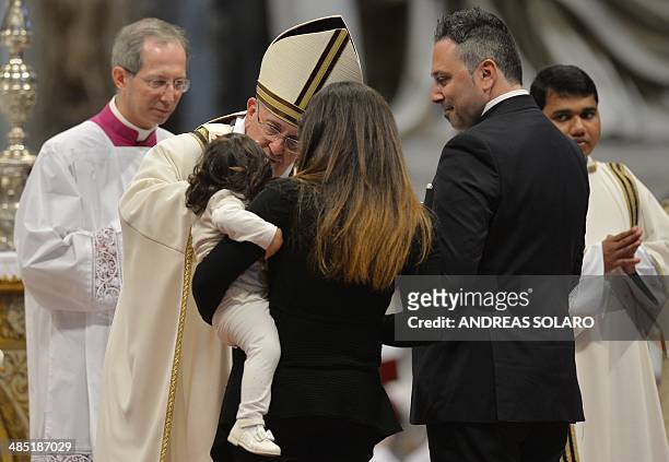 Pope Francis blesses a child during a Chrism mass for Maundy Thursday , on April 17, 2014 at St Peter's Basilica in Vatican. The Chrism Mass marks...