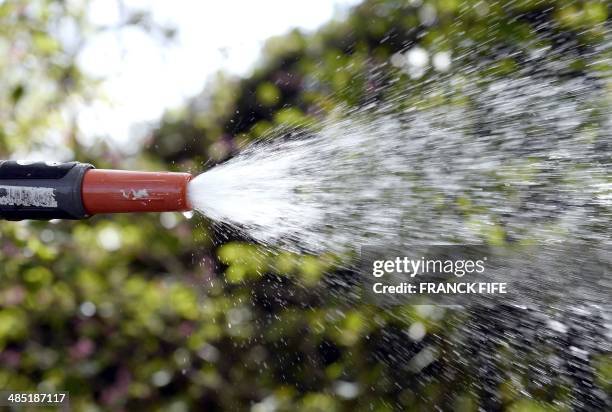 Water comes out of a hose pipe as a person waters his garden in Weinbourg, eastern France, on April 16, 2014. AFP PHOTO / FRANCK FIFE / AFP PHOTO /...