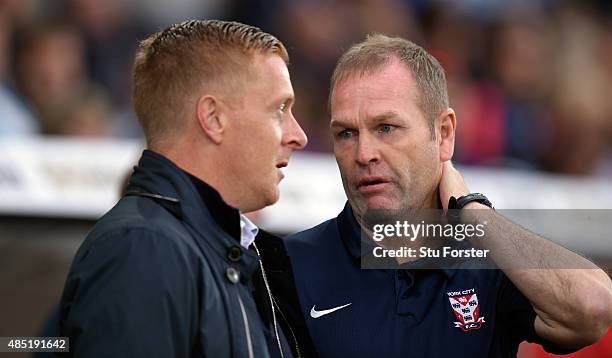 Swansea manager Garry Monk chats with his opposite number Russ Wilcox before the Capital One Cup Second Round match between Swansea City and York...