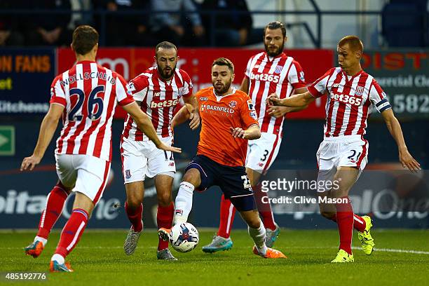 Josh McQuoid of Luton Town takes on the Stoke City defence Philipp Wollscheid, Marc Wilson, Erik Pieters and Steve Sidwell during the Capital One Cup...