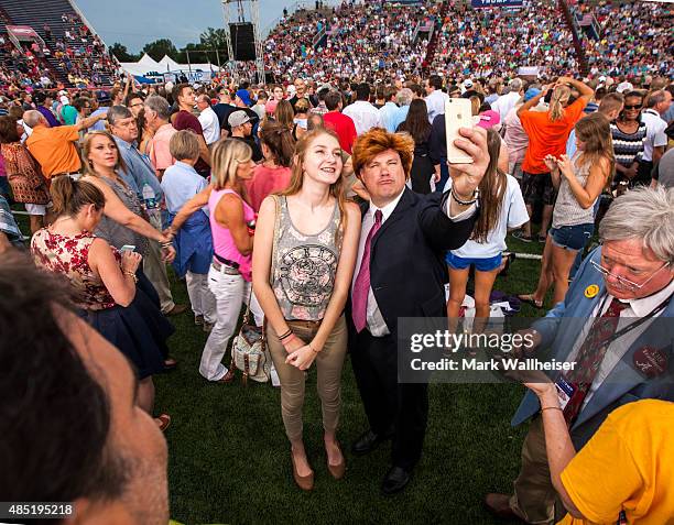 Christinia Matis, of Coden, Alabama, poses with Mobile radio DJ Matt McCoy dressed up as Donald Trump prior to the arrival of U.S. Republican...