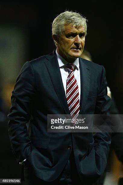 Mark Hughes, Manager of Stoke City looks on during the Capital One Cup second round match between Luton Town and Stoke City at Kenilworth Road on...
