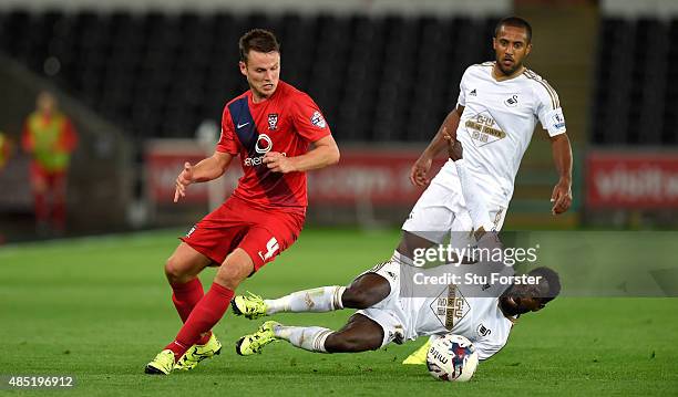 Swansea player Nathan Dyer challenges James Berrett of York during the Capital One Cup Second Round match between Swansea City and York City at...