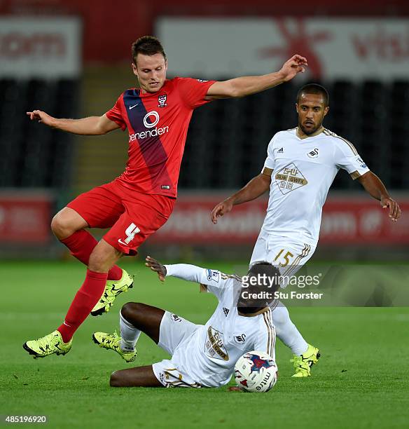 Swansea player Nathan Dyer challenges James Berrett of York during the Capital One Cup Second Round match between Swansea City and York City at...