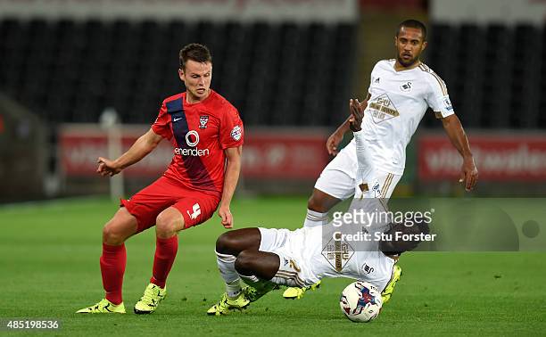Swansea player Nathan Dyer challenges James Berrett of York during the Capital One Cup Second Round match between Swansea City and York City at...