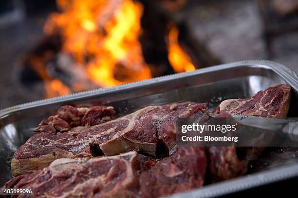 Fresh cut steaks from Argentine beef cows are prepared to be grilled on a farm outside of San Antonio de Areco, Argentina, on Saturday, July 25,...