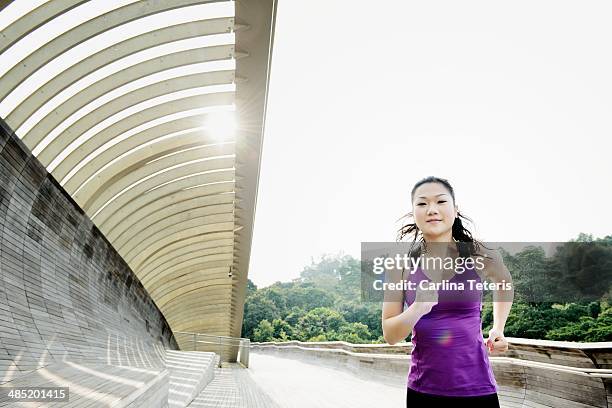 chinese woman running along henderson wave bridge - henderson waves bridge stock pictures, royalty-free photos & images