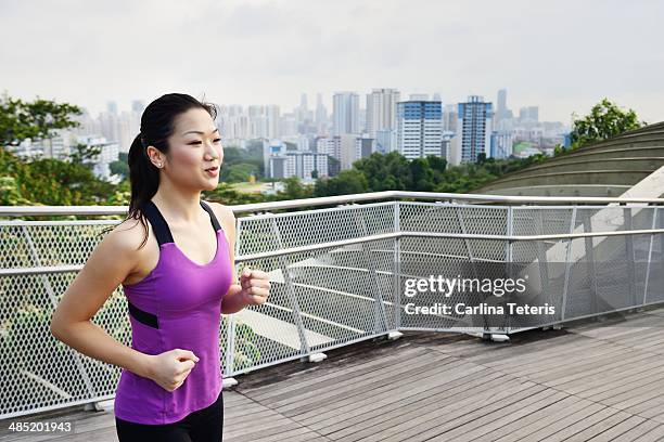 chinese woman running on henderson waves - henderson waves bridge stock pictures, royalty-free photos & images
