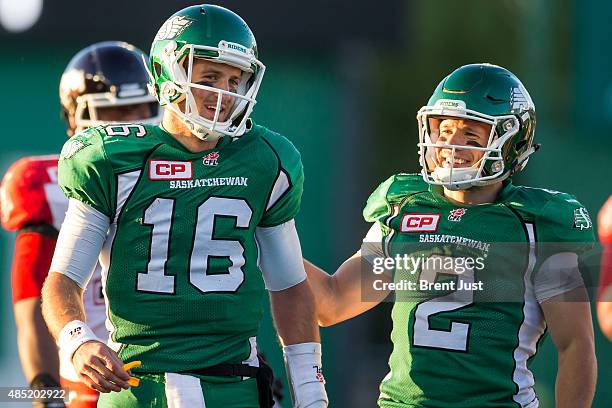 Ryan Smith of the Saskatchewan Roughriders is smiles at quarterback Brett Smith after taking a big hit at the end of scrambling for a first down in a...
