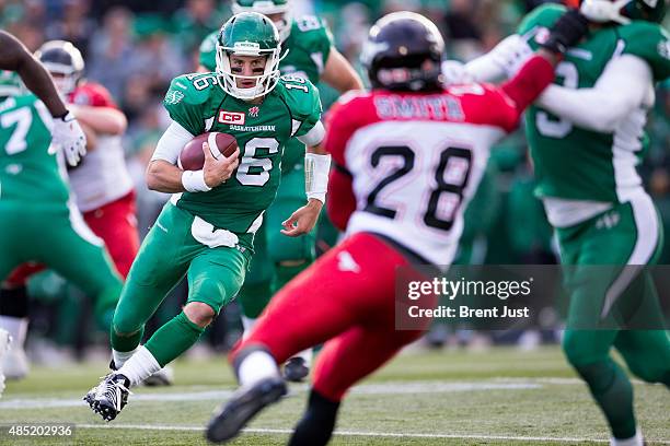 Brett Smith of the Saskatchewan Roughriders looks for a block as he scrambles in a game between the Calgary Stampeders and Saskatchewan Roughriders...