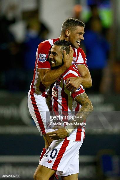 Geoff Cameron of Stoke City celebrates scoring the winning penalty with Jonathan Walters after the penalty shoot-out during the Capital One Cup...