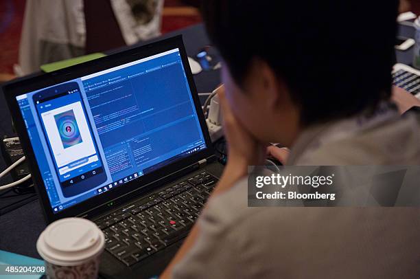 An attendee working on a laptop computer participates in the Yahoo! Inc. Mobile Developer Conference Hackathon in New York, U.S., on Tuesday, Aug....