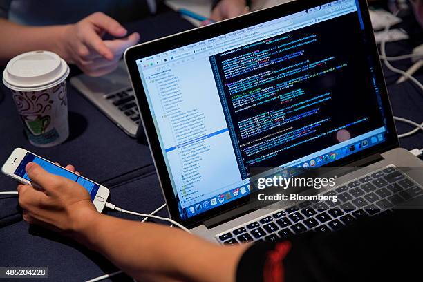 Attendees working on Apple Inc. Laptop computers participate in the Yahoo! Inc. Mobile Developer Conference Hackathon in New York, U.S., on Tuesday,...