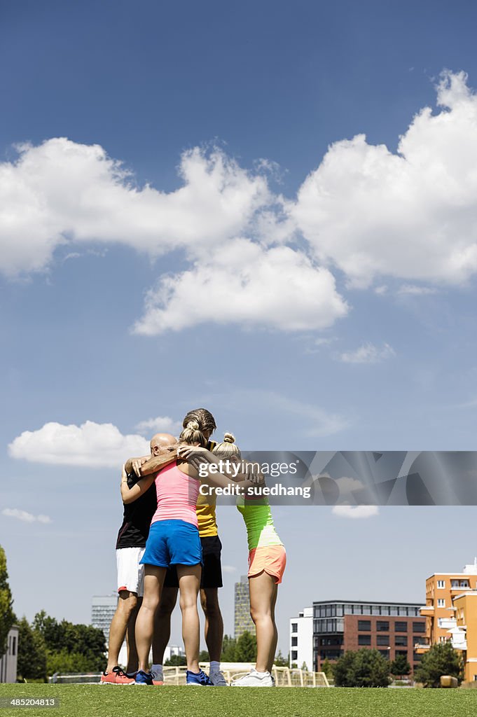 Exercise group huddled together in park