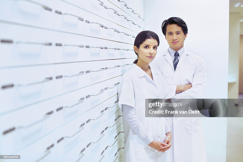 Portrait of male and female pharmacists in pharmacy