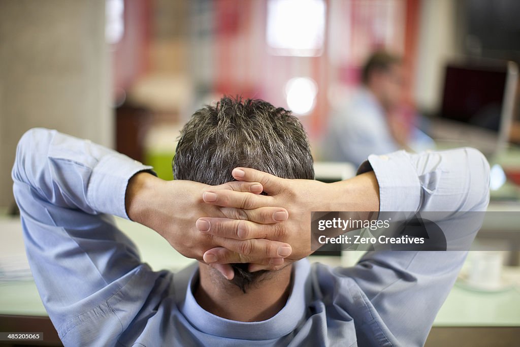 Mature businessman relaxing in office