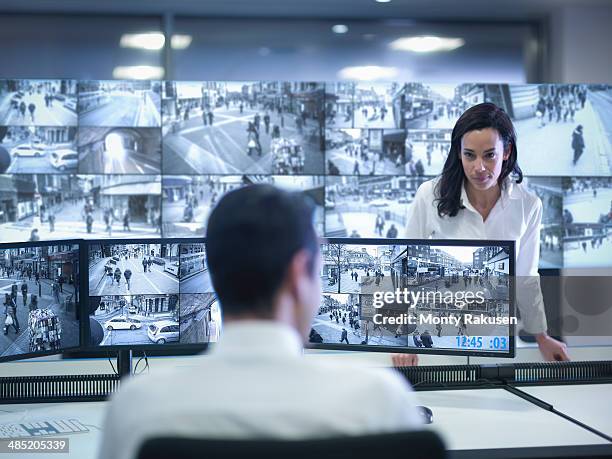 security guards working at cctv screens in control room - south ruislip stock pictures, royalty-free photos & images