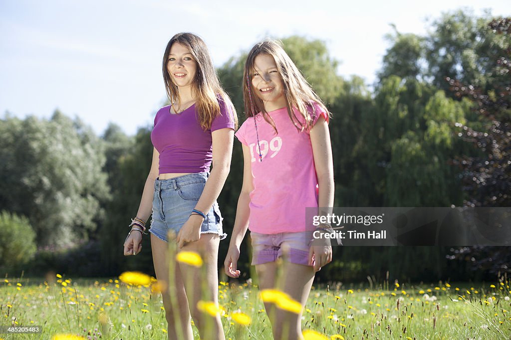 Portrait of teenage girl and her sister in park