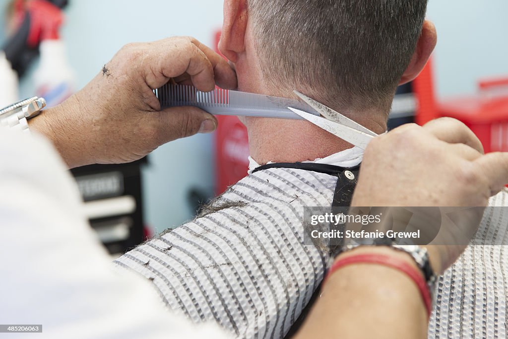 Barber cutting man's hair