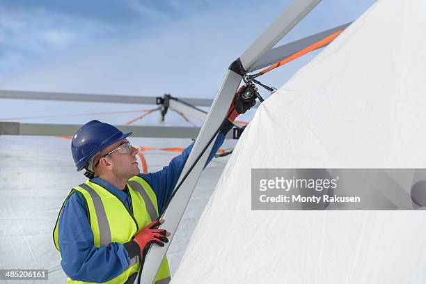 emergency response team worker erecting tent control centre - heysham stock pictures, royalty-free photos & images