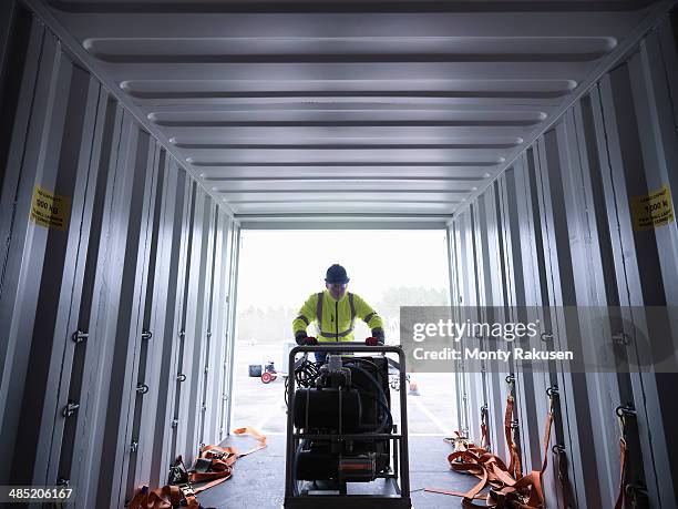 emergency response team worker unloads equipment from shipping container - offloading stock pictures, royalty-free photos & images