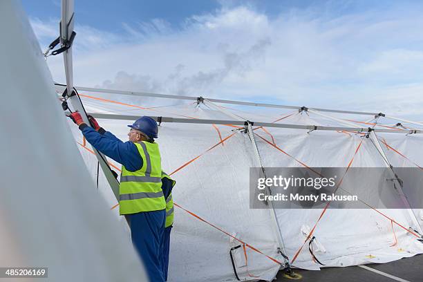 emergency response team workers erecting tent control centre - heysham stock pictures, royalty-free photos & images