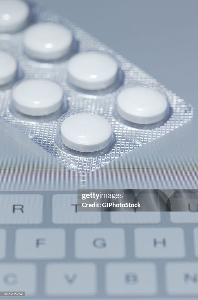 Buying drugs online. Blister pack containing 250-mg Erythromycin tablets on the screen of a tablet computer