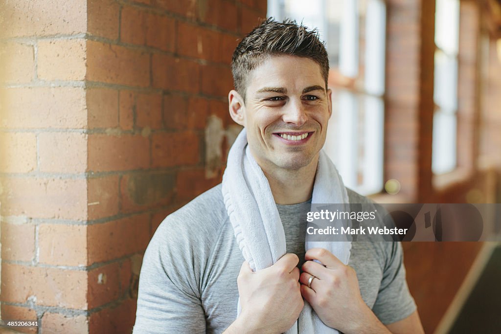 Man in gym with towel around neck