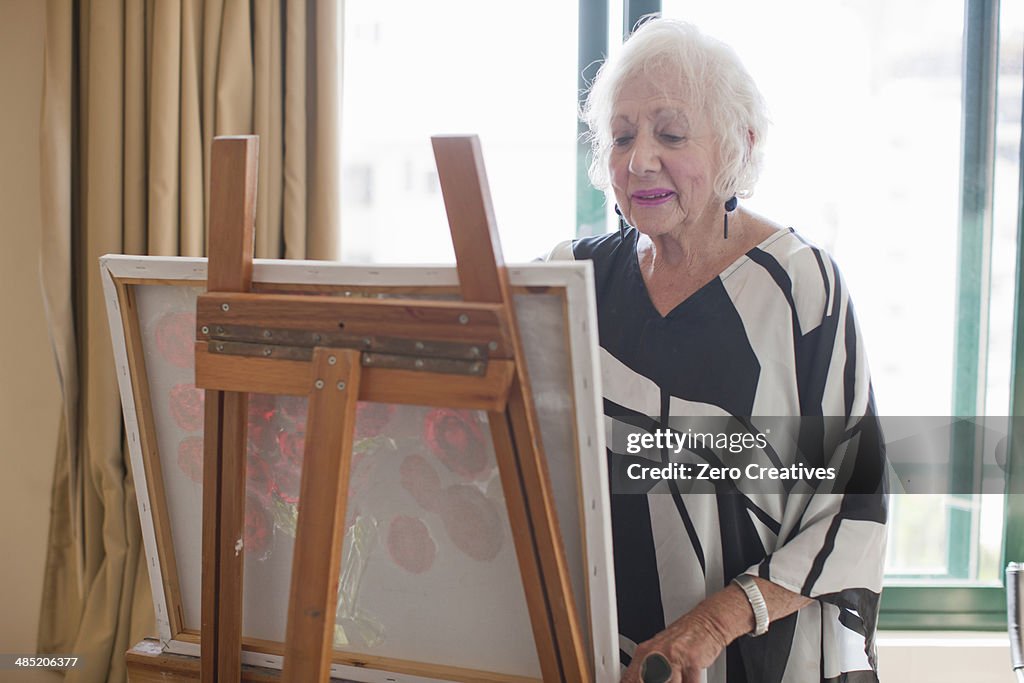 Senior women painting art canvas in retirement villa