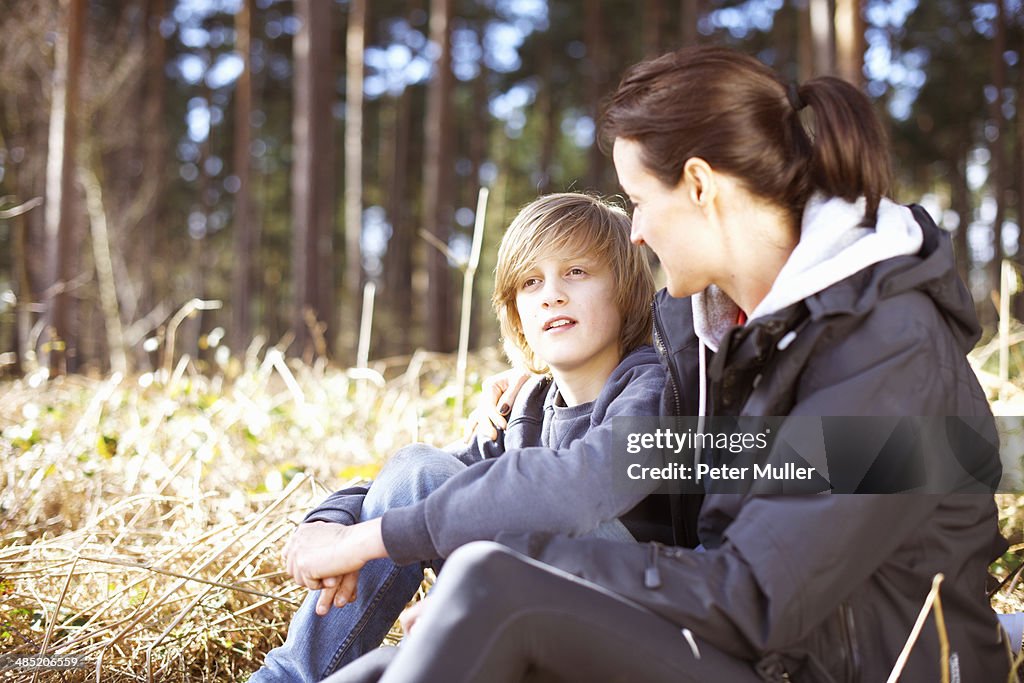 Mature woman taking a break with her son in a forest