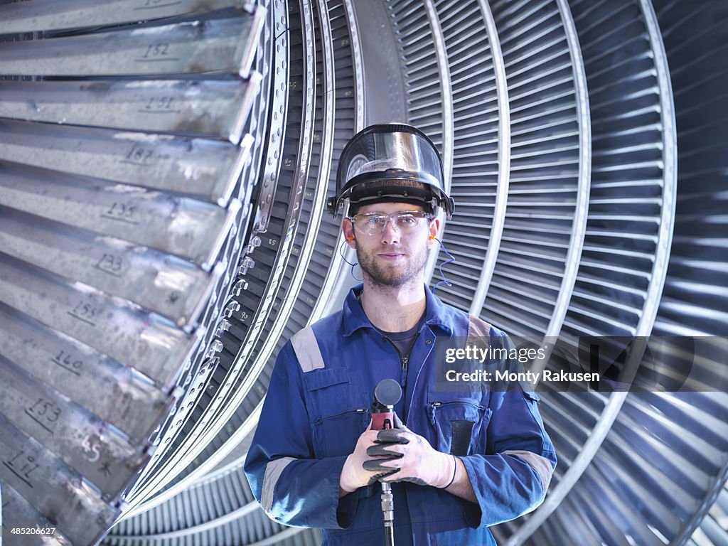 Portrait of apprentice engineer in steam turbine repair workshop
