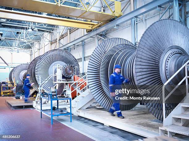 engineers with low pressure steam turbines in repair bays in workshop - hydroelectric power stock pictures, royalty-free photos & images