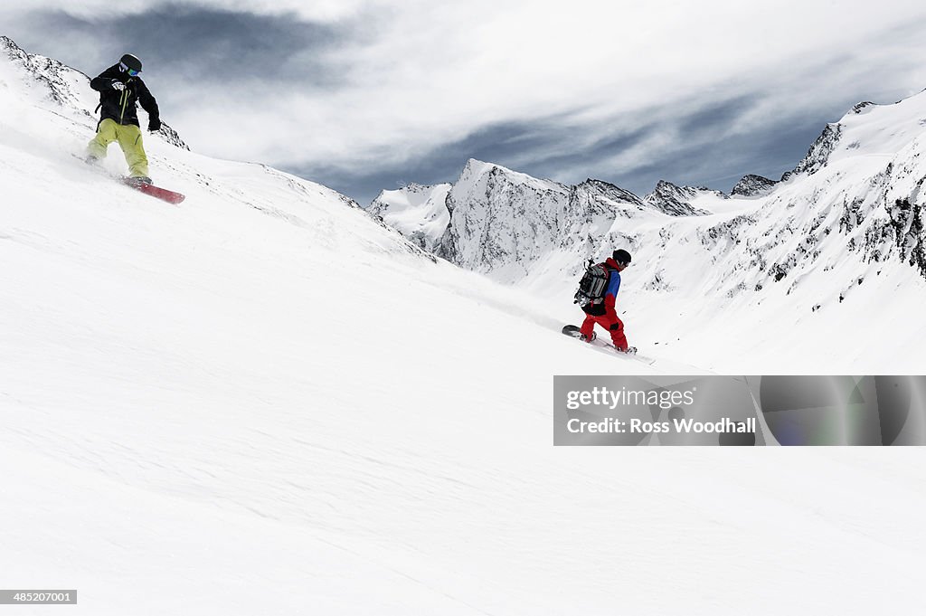 Two men snowboarding downhill, Obergurgl, Austria