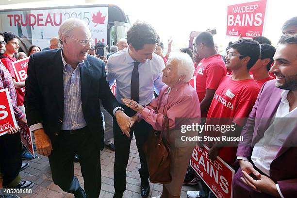 Federal Liberal Leader Justin Trudeau and former Prime Minister Paul Martin greet former Mississauga Mayor Hazel McCallion as he campaigns during the...