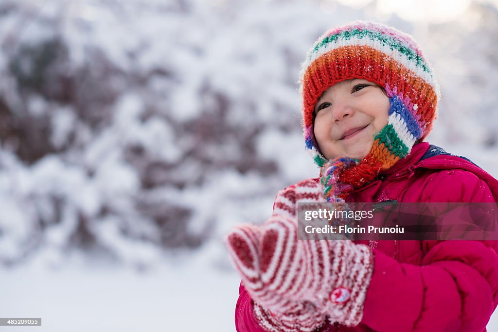 Young girl enjoying winter snow