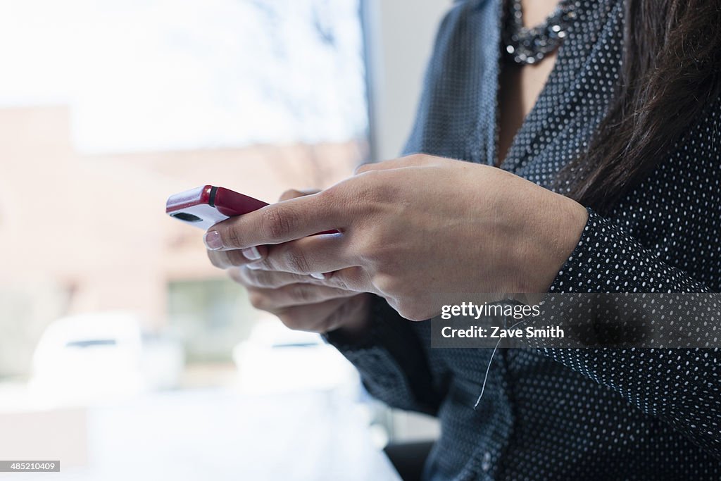 Young businesswoman using smartphone