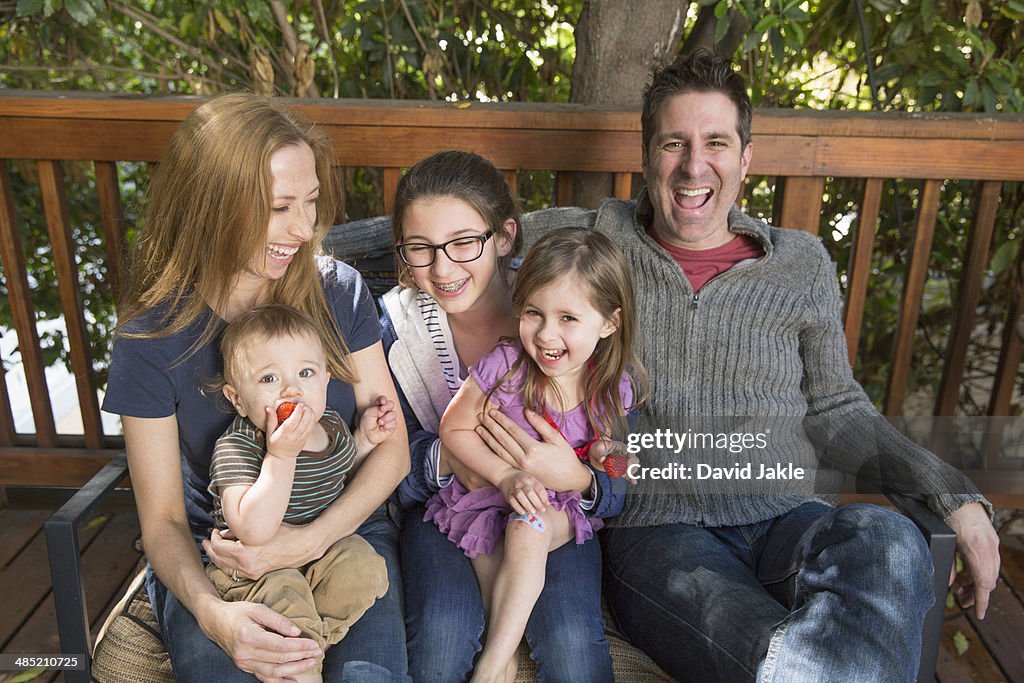 Happy family relaxing on porch