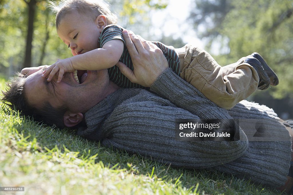 Father and son playing on grass