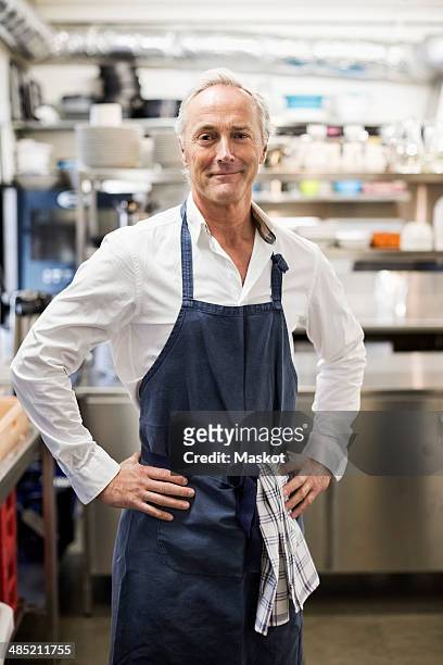 portrait of confident chef standing in commercial kitchen - chef man ストックフ�ォトと画像
