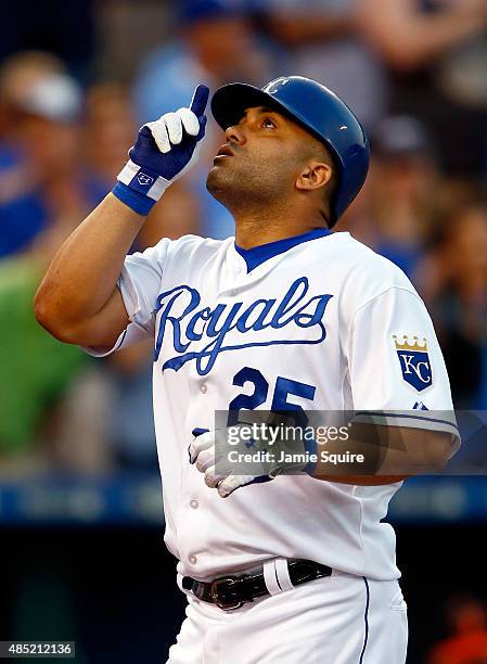 Kendrys Morales of the Kansas City Royals points skyward as he crosses home plate after hitting a solo home run during the 2nd inning of the game...