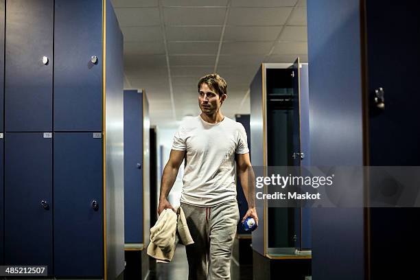 man walking in locker room of health club - spind stock-fotos und bilder