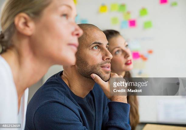 business people looking away in creative office - group people thinking stock pictures, royalty-free photos & images