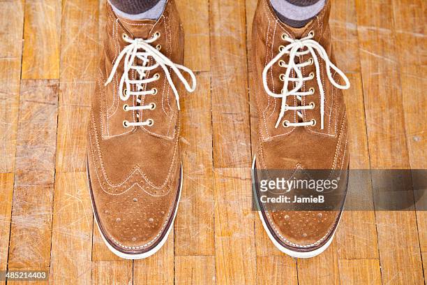 close up of mans feet wearing suede boots - suede shoe stock pictures, royalty-free photos & images