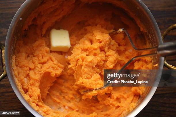sweet potato mash with a knob of butter - stampen stockfoto's en -beelden
