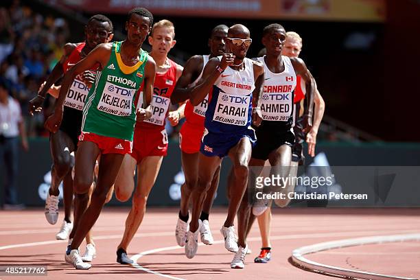 Yomif Kejelcha of Ethiopia and Mohamed Farah of Great Britain compete in the Men's 5000 metres heats during day five of the 15th IAAF World Athletics...